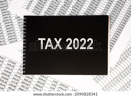 Tax 2022, taxation system. Word text on calculator.