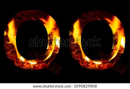 The letter Q made from fire and burning wood on a black background, a double version of the alphabet for decorative signatures.