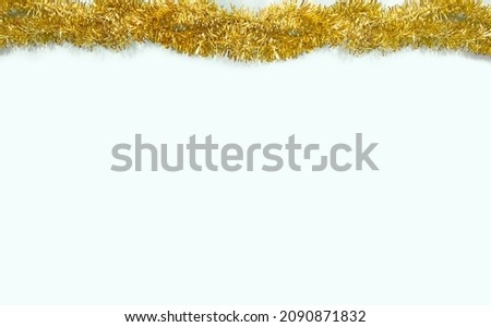 Christmas theme. Gold Garland  on a light blue background, view from top. Flat lay, top view, copy space. New Year, Minimal concept.