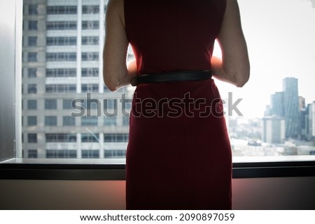 View of a woman looking out the window