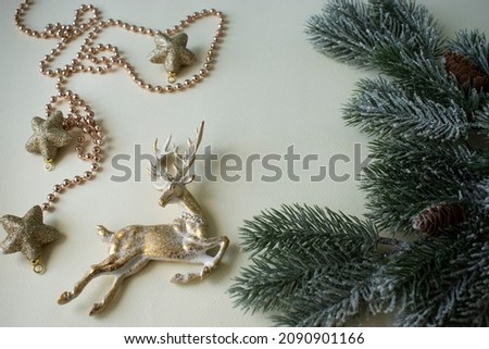 christmas composition fir-tree branches, golden stars and deer
