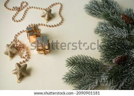 Christmas composition fir-tree branches, golden stars and gifts
