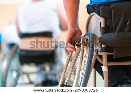 Close-up of sportsman with disability sitting in wheelchair playing basketball