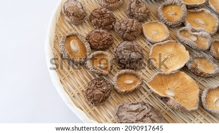 Japanese dried shiitake mushrooms on a bamboo basket.