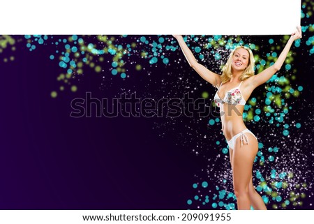 Young attractive blond in bikini holding blank banner