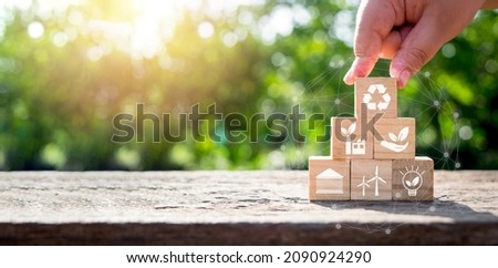 ESG concept of environmental, Man hand holding wooden cube block with ESG icon with copy space, social and corporate governance concept Royalty-Free Stock Photo #2090924290