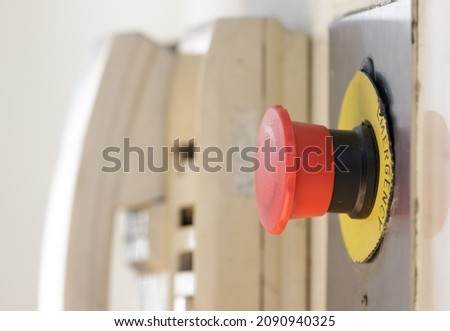 red emergency button with blur telephone background near factory elevator.