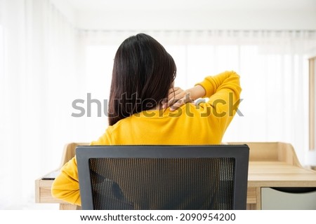Office syndrome concept. Young asian woman feeling pain in neck after working on computer laptop for a long time Royalty-Free Stock Photo #2090954200