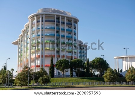 The building of the hotel against the blue sky. Russia Sochi November 2021. Hotel with balconies in the colors of the Olympic flag. Hotel Omega Sirius. Rest in the resort town. Royalty-Free Stock Photo #2090957593