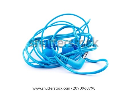 Blue earbuds isolated on white background. Tangled and twisted wire headphones. Royalty-Free Stock Photo #2090968798