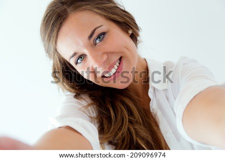 Portrait of beautiful blonde girl taking selfie. Isolated on white. 