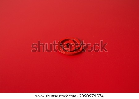 Red wooden symbol "at" on red background and copy space for social media educational concept