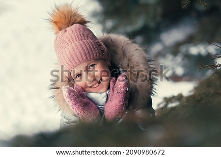 Portrait of a happy girl in a winter fir forest