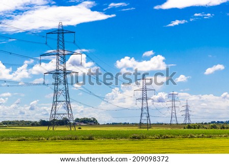 Row of Pylons in the English countryside Royalty-Free Stock Photo #209098372