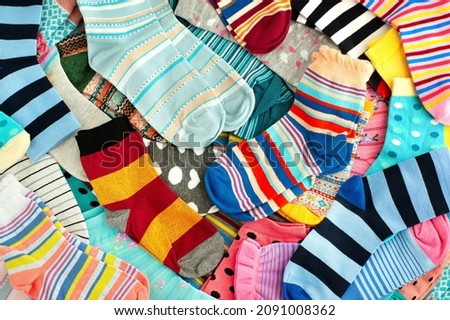 A bunch of colorful socks. Many different colorful socks for cold seasons. Clothing in the form of socks. Royalty-Free Stock Photo #2091008362
