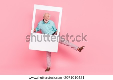 Full body photo of energetic middle age man hold photograph border dance disco isolated pastel color background