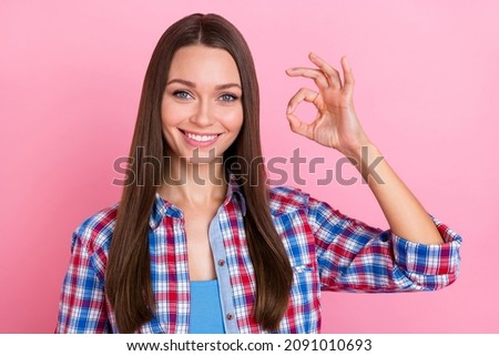 Photo of optimistic brunette young lady show okey wear blue red shirt isolated on pastel pink color background