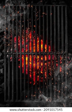 Top view through black barbecue grate of burning coals with sparks and white smoke Royalty-Free Stock Photo #2091017545