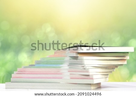 books on reading table with natural bokeh background. concept of learning and education