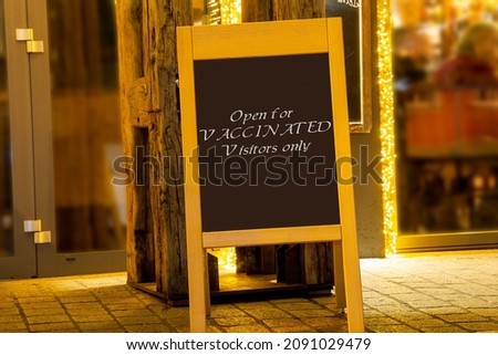 Signboard in front of a restaurant with the inscription  Open for Vaccinated Visitors only (Symbolic image, Composing)
