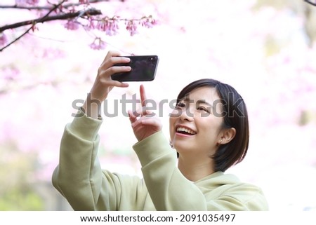 Female taking pictures with a smartphone 
