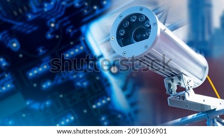 Video surveillance technologies. A video camera in an anti-vandal case. A camera in a metal case against the background of printed circuit boards. The security system in the building. Royalty-Free Stock Photo #2091036901
