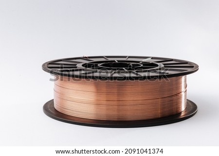Welding wire spool on a white background. Royalty-Free Stock Photo #2091041374