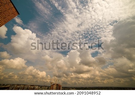 Big and fluffy cumulonimbus cloud against  blue sky