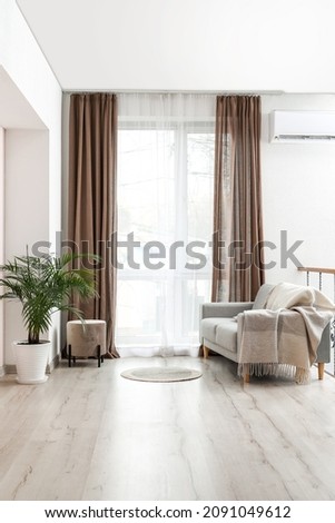 Interior of stylish living room with light curtains Royalty-Free Stock Photo #2091049612