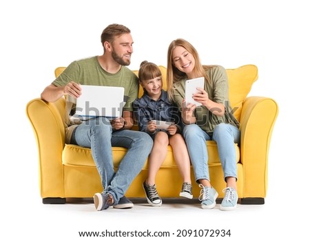 Happy family with gadgets on sofa against white background
