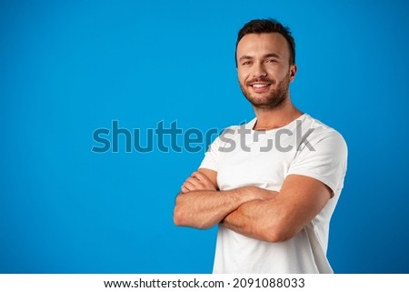 Happy smiling handsome man against blue background