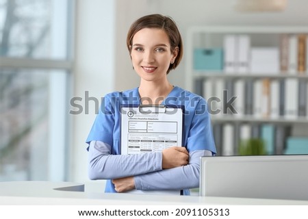 Female receptionist with clipboard in clinic