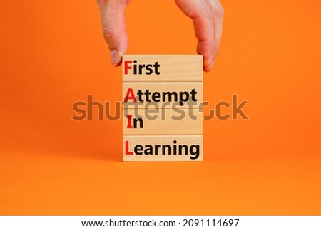 FAIL first attempt in learning symbol. Wooden blocks with words FAIL first attempt in learning. Beautiful orange table, orange background, copy space. Business, FAIL first attempt in learning concept. Royalty-Free Stock Photo #2091114697