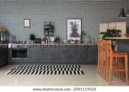 Cooking utensils and products on table in interior of modern kitchen