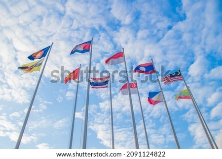 
Flags of 10 ASEAN countries, taken from a low angle. Show grandeur and blue sky with many white clouds. It is used in jobs related to alliance and unity or jobs related to economy or politics. Royalty-Free Stock Photo #2091124822