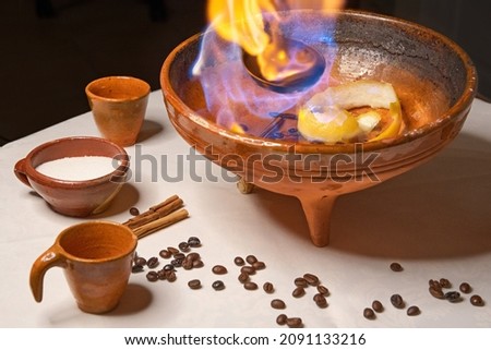 Ingredients to make a "queimada", a typical drink from Galicia (northern Spain). It is made with brandy, sugar, lemon peel, coffee beans and cinnamon and an incantation must be pronounced beforehand Royalty-Free Stock Photo #2091133216