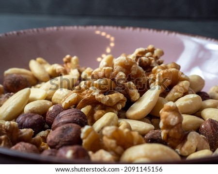 Mix nuts on a wooden background.