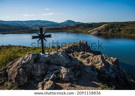 The cross by the temple of the Medieval chapel St. Yoan Letni overlooking Pchelina dam in Bulgaria. High quality photo