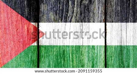 Grunge pattern of Palestine national flag isolated on weathered wooden fence board. Abstract Palestine politics history culture concept background