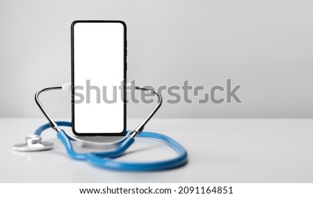 Online doctor. Mobile phone mockup for medical app. Smartphone white screen mockup and stethoscope for health application. App health phone mockup. Banner with copy space Royalty-Free Stock Photo #2091164851