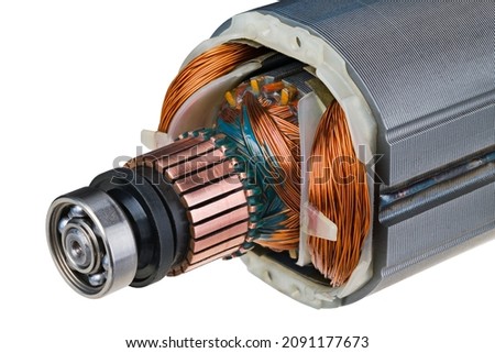 Rotor and stator detail of electric DC motor isolated on a white background. Steel ball bearing, copper commutator and electromagnetic coil wire winding with green epoxy resin in ferromagnetic sheets. Royalty-Free Stock Photo #2091177673