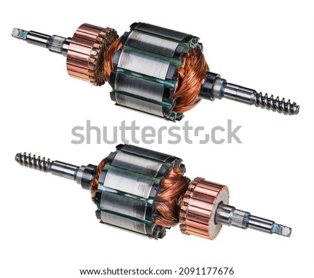Electric DC motor rotors with copper commutator and coil wire winding isolated on white background. Two engine parts with steel laminations. Worm screw shaft on one side and grooving for fan on other. Royalty-Free Stock Photo #2091177676