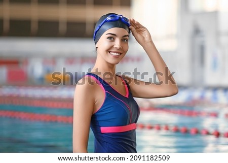 Sporty female swimmer in pool Royalty-Free Stock Photo #2091182509