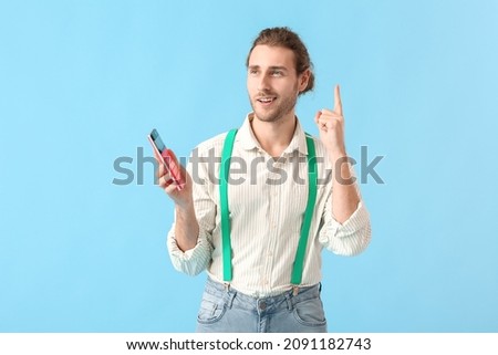 Thoughtful man with calculator on color background