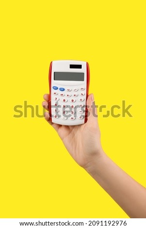 Woman with calculator on color background
