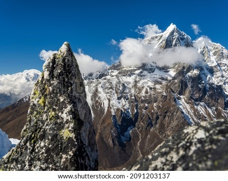 triangle stone and view to summits under blue sky in valley Khumbu in Nepal