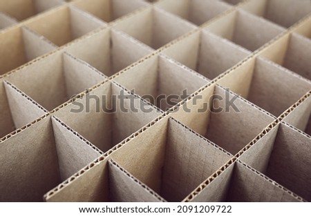 Abstract background. Square cardboard partitions close-up. Partitions for transporting fragile glass items. Royalty-Free Stock Photo #2091209722