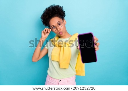 Photo of young african girl impressed plump lips show mobile promotion advertise isolated over blue color background