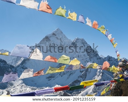 wide angle view to snow peaks through buddha prayer flags in Nepal in sun shining day Royalty-Free Stock Photo #2091235159