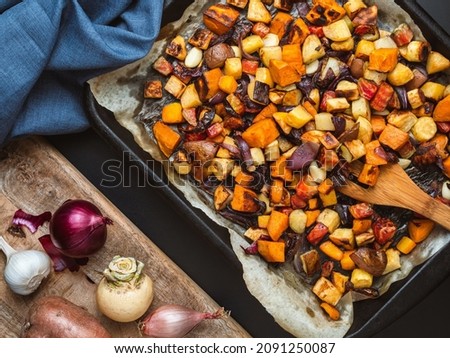 Roasted root vegetables on a baking sheet. Royalty-Free Stock Photo #2091250087